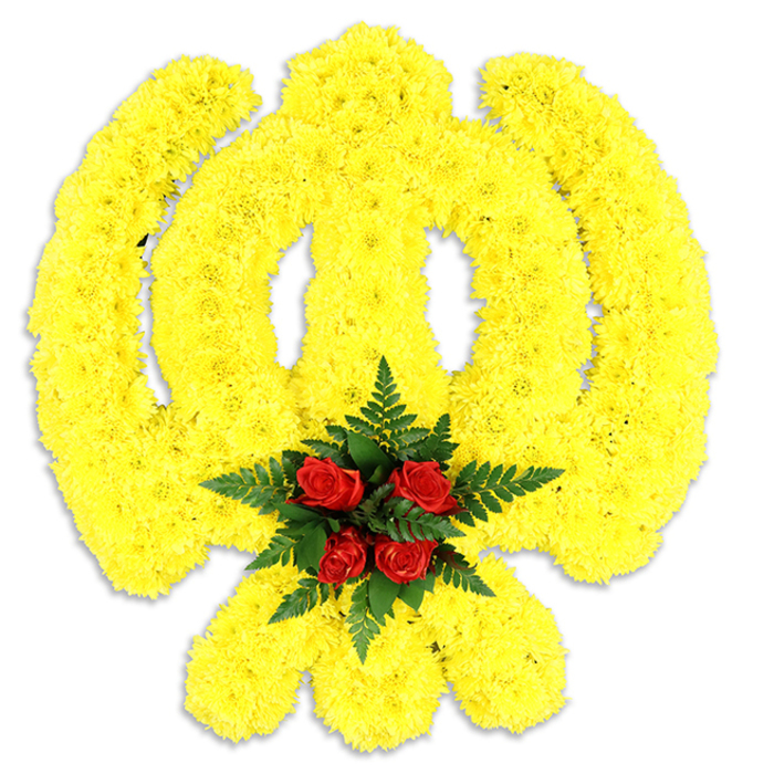 A large, formally composed floral emblem rests against a pure white background, its shape rendered in a wash of bright, sunny yellow from thousands of small chrysanthemum blooms. The dense, uniform placement of each yellow head builds up the emblem's familiar geometry - the circular chakkar, the prominent central double-edged khanda blade, and the two crossed kirpans - so that the symbol reads clearly from a respectful distance while revealing textured detail close up. At the very centre, where the circular and linear elements converge, a compact cluster of deep red roses provides a deliberate point of contrast: rich, velvety petals nestle within a cushion of dark green fern fronds, which frame and lift the roses visually above the yellow field. The arrangement catches a soft, diffuse light that produces a slender grey shadow underneath, giving the piece modest depth without distracting from its form. The olfactory impression would be subtle - a gentle chrysanthemum sweetness with underlying rose warmth and a clean green note from the ferns - appropriate for solemn occasions. Crafted with the precision of an experienced florist familiar with local customs in Harold Wood and neighbouring Gubbins Lane communities, this composition is intended as a dignified tribute for memorial services, religious gatherings, or cultural commemorations. Its scale and clarity communicate both reverence and celebration of heritage, making it a considered choice for families seeking a meaningful floral representation of faith and remembrance.