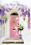 In this Harold Wood doorway, a gentle sense of celebration settles into every detail, as if the house has just received its first set of keys. A pale pink front door, soft and chalky in finish, glows at the centre of the image, its pastel tone echoed in a single shutter leaned neatly against a whitewashed wall. The paintwork is smooth yet slightly brushed, catching the afternoon light in subtle streaks that suggest warmth rather than glare. From above, wisteria tumbles down in generous, fragrant cascades, its long chains of blossoms shaded from cool lavender to dusty lilac, creating a layered curtain around the top and sides of the doorway. The twisting woody stems and scattered leaves lend a natural, slightly untamed frame to the carefully painted façade, giving the impression that the house and the plant have grown together over time. On the doorstep itself, resting firmly on the stone, a rounded grey bucket becomes a vessel for a thoughtfully crafted bouquet. It brims with creamy white roses, their petals full and velvety, opening in soft rosettes that overlap in a cloud-like mass. Between the blooms, touches of fresh green foliage peek through, adding depth and a sense of living movement. Around the base, a satin pink ribbon is tied in a relaxed, elegant bow, its sheen catching the light and its trailing ends echoing the fall of the wisteria above. You can almost feel the coolness of the shaded doorway and imagine the mixed fragrance of roses and wisteria drifting out to the pavement, signalling to neighbours along Gubbins Lane that someone is being quietly celebrated. The whole scene feels like a floral blessing on a new Harold Wood home, a visual wish for comfort, joy, and a welcoming start to the next chapter.